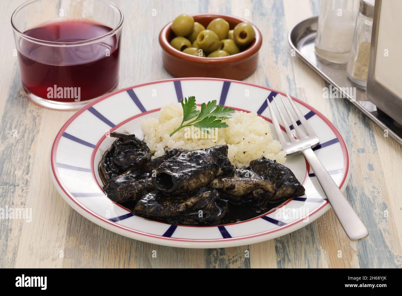 chipirones en su tinta, small squid cooked in black ink, spanish basque ...