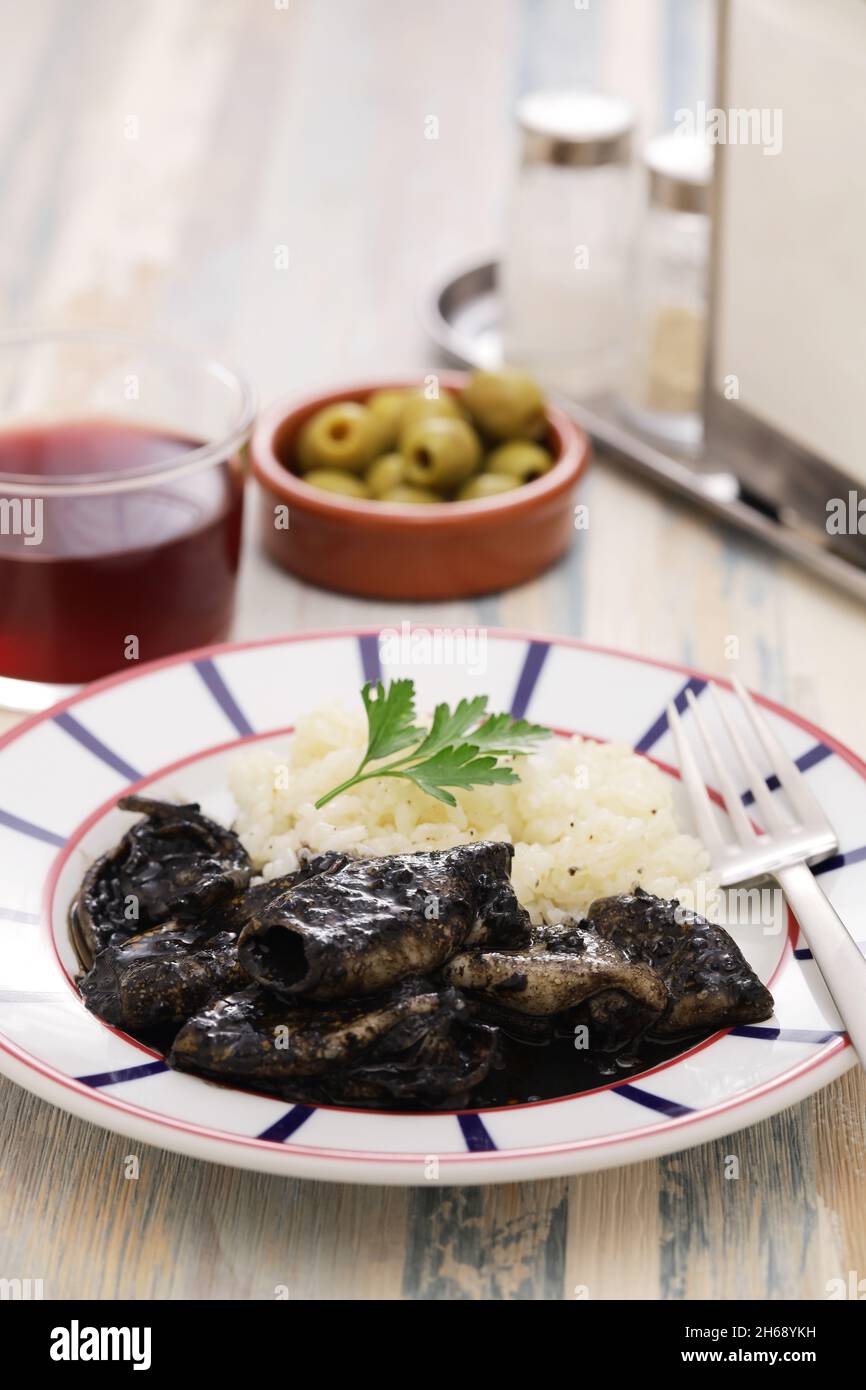 chipirones en su tinta, small squid cooked in black ink, spanish basque ...