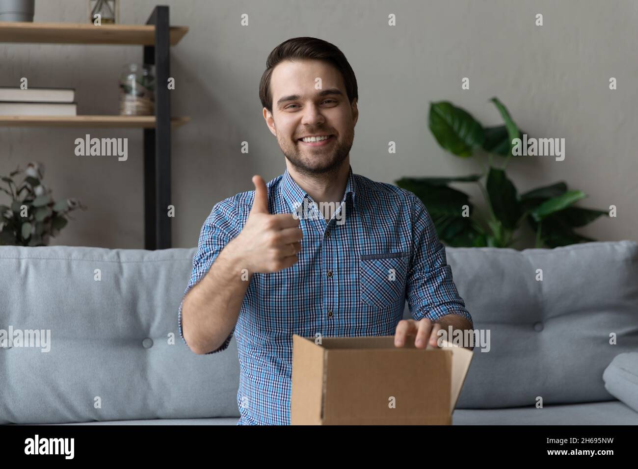 Happy young man recommending fast delivery service. Stock Photo
