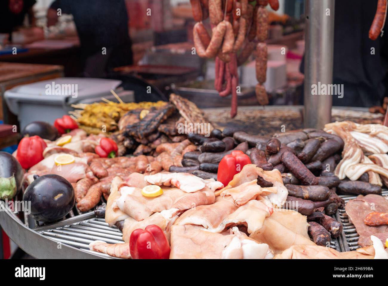 a large grill with different meats, sausages and vegetables on an open fire in the open air at a city festival dedicated to the Middle Ages Stock Photo