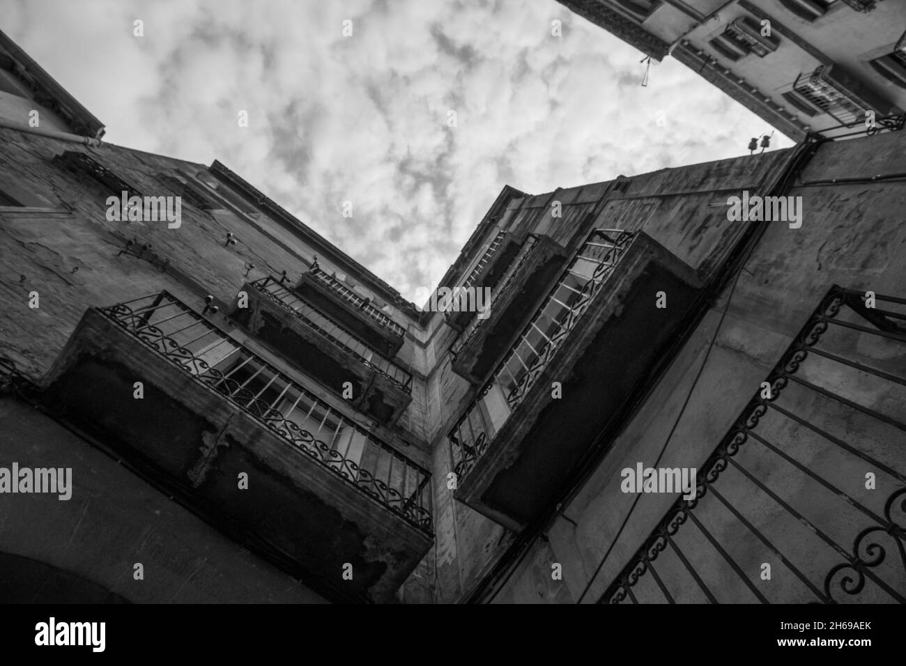 A low angle shot of old apartment buildings with balconies Stock Photo