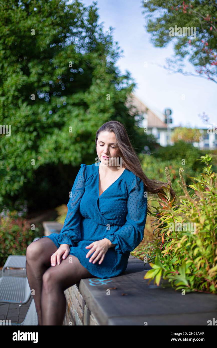 White young european woman in autumn park in bright blue dress Stock Photo  - Alamy