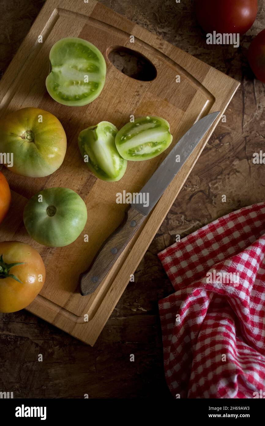 A top view of fresh green tomatoes on a cutting board Stock Photo - Alamy