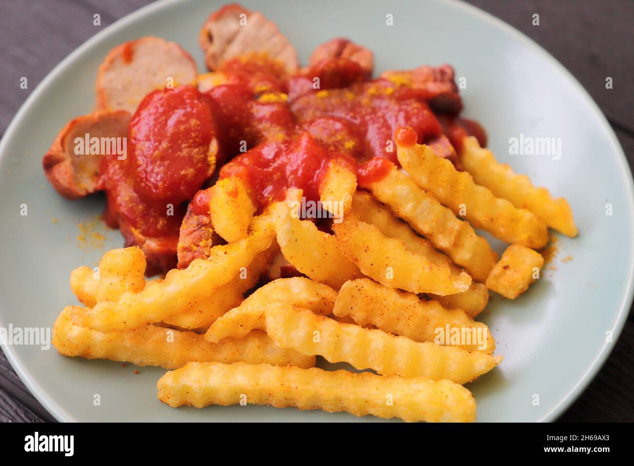 delicious sausage with french fries and curry sauce Stock Photo Alamy