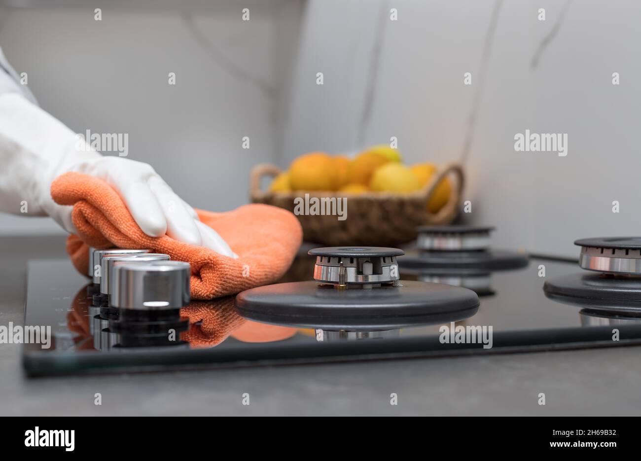 Person hand in rubber glove wiping kitchen top Stock Photo Alamy