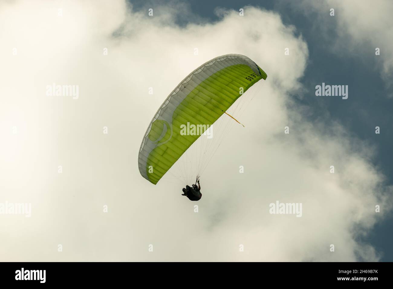 Appenzell, Switzerland, June 13, 2021 Parachute is gliding in the blue sky over the swiss alps Stock Photo