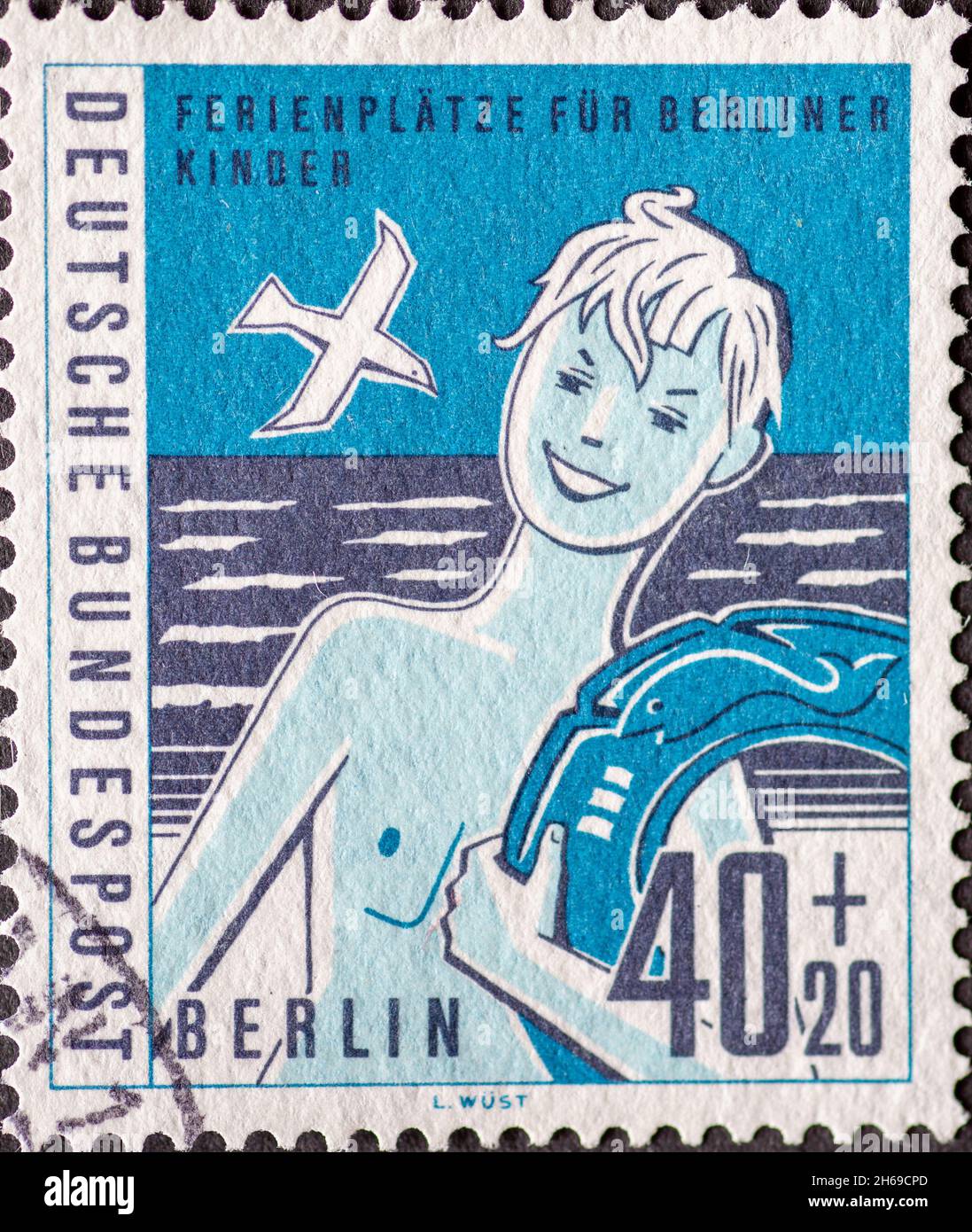 GERMANY, Berlin - CIRCA 1960: a postage stamp from Germany, Berlin has the motto: Vacation spots for children in Berlin Here: boy with a swim ring by Stock Photo