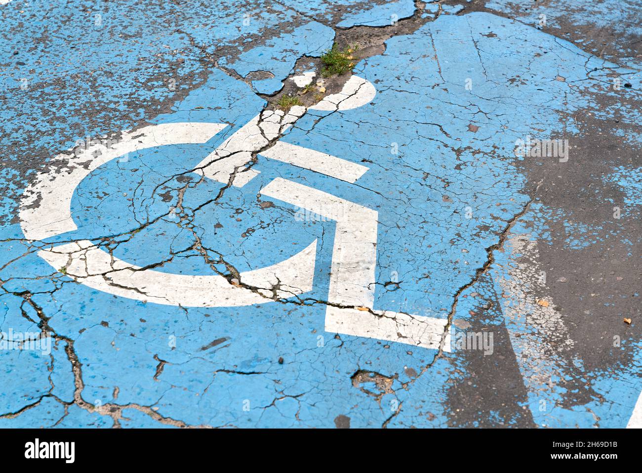 blue marked disabled parking place on a street in Kolobrzeg in Poland Stock Photo