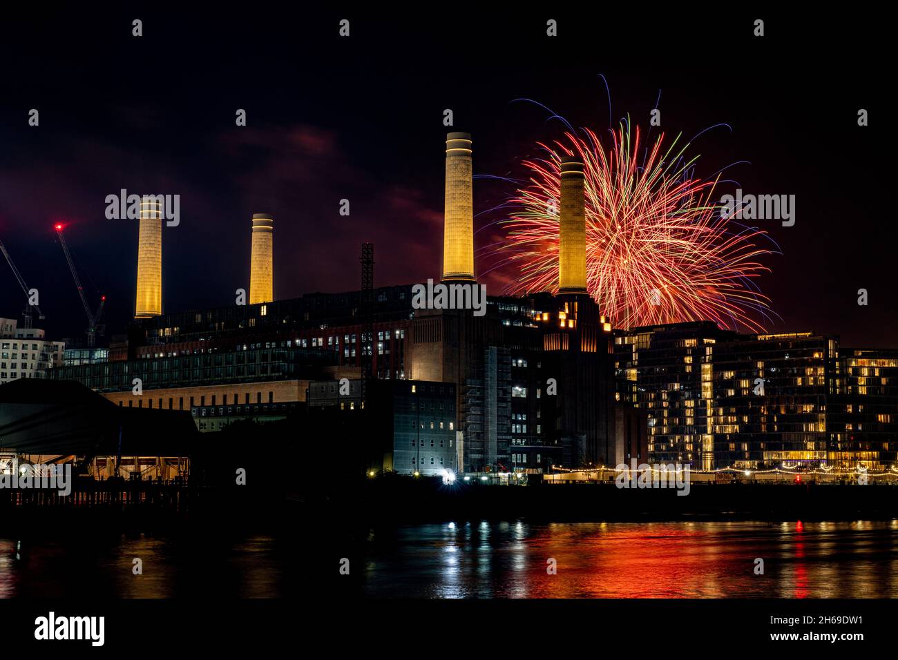 Battersea Fireworks light the sky behind and illuminated Battersea Power Station 2021 Stock Photo