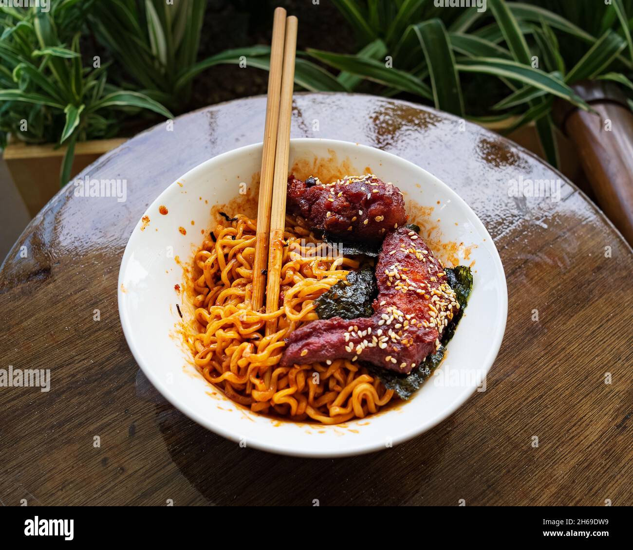 Korean hot spicy fried chicken served with ramen instant noodles, stir