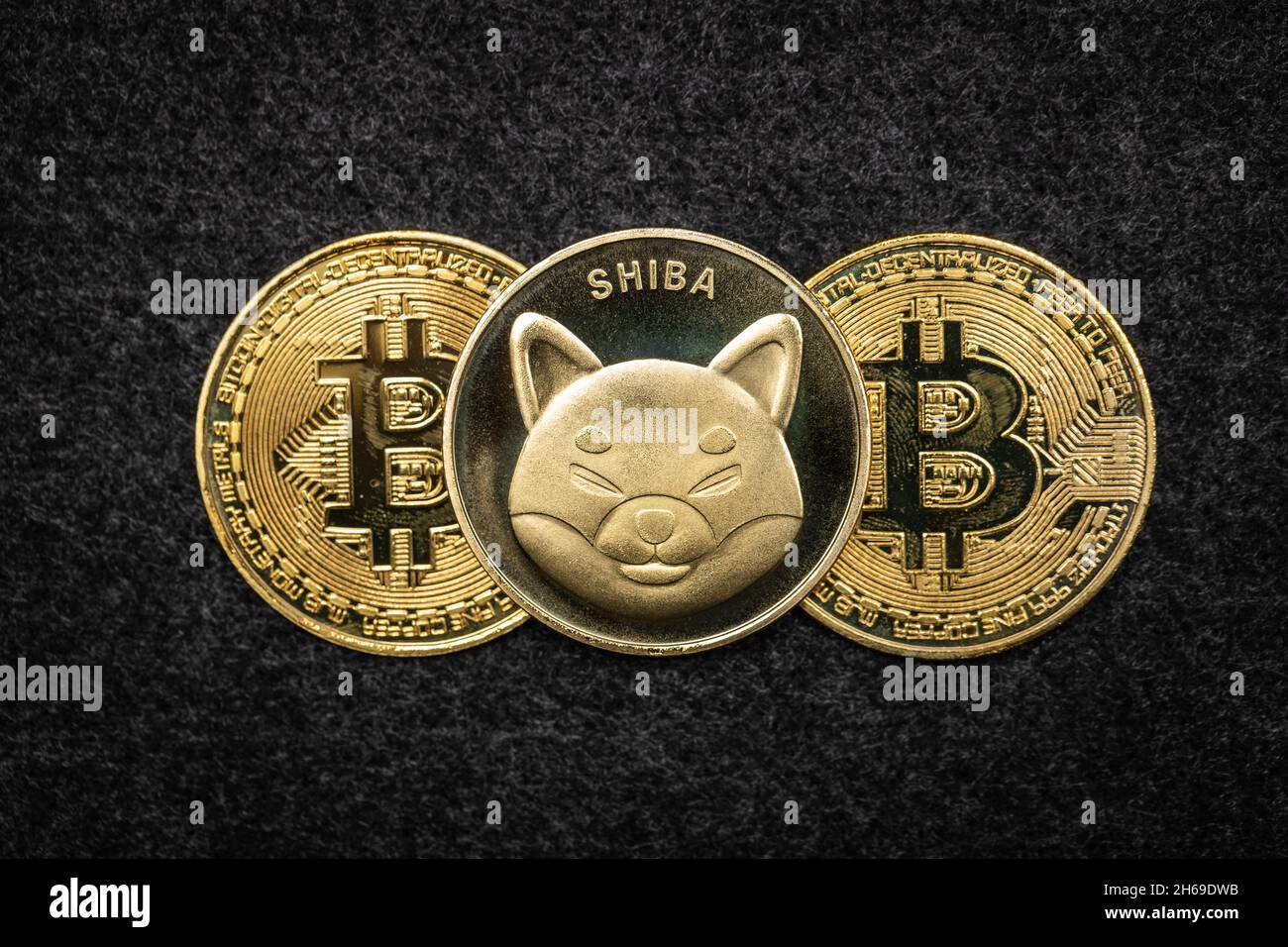 Shiba Inu Coin on top of Bitcoin physical coins Stock Photo - Alamy