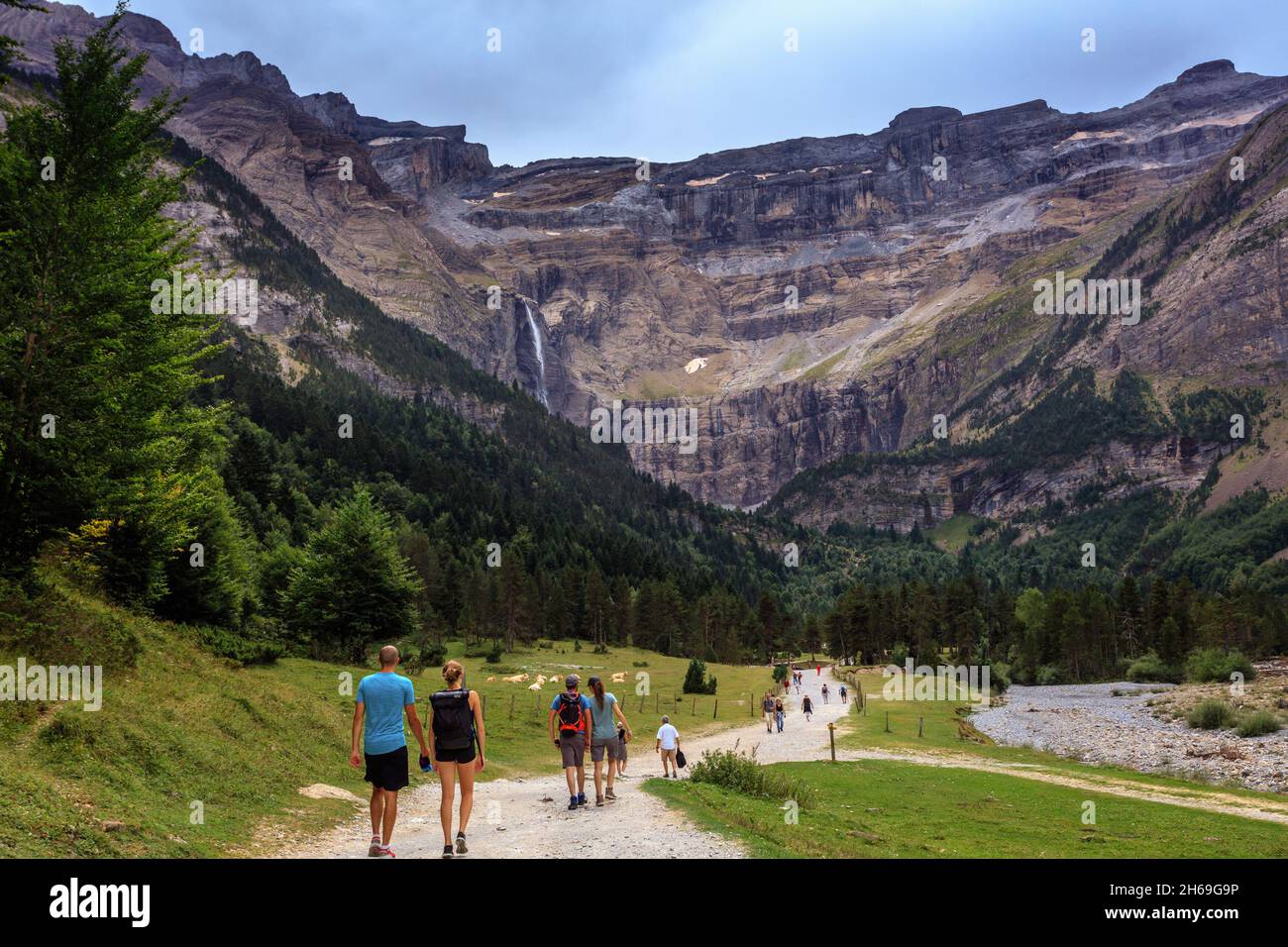 Hikers walk in the Cirque de Gavarnie in the French Pyrenees National Park, a UNESCO World Heritage Site. The Cirque was shape by a glacier. Stock Photo