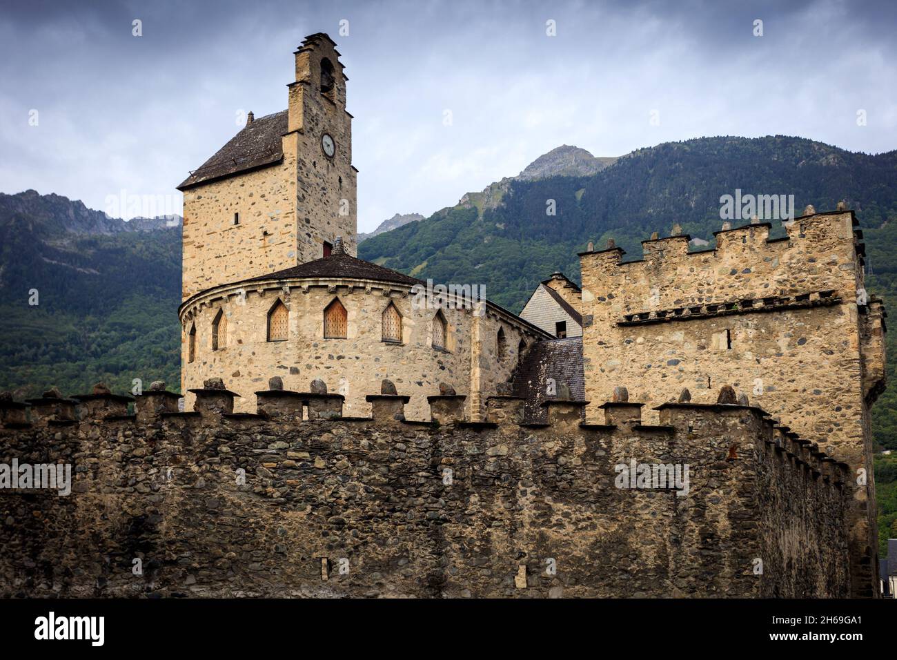 The Templars, a romanesque church in the village of Luz Saint Sauver in the French Hautes Pyrenees. The Saint Andre church is surrounded by a wall. Stock Photo