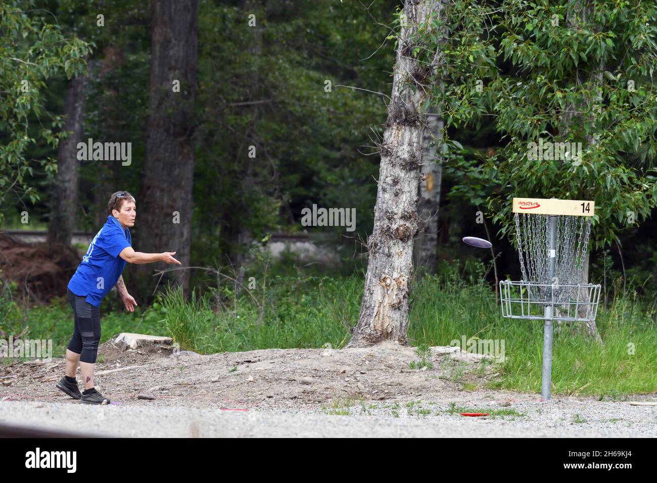 Playing disc golf at the Timber Beast Disc Golf Course in Troy, northwest Montana. (Photo by Randy Beacham) Stock Photo