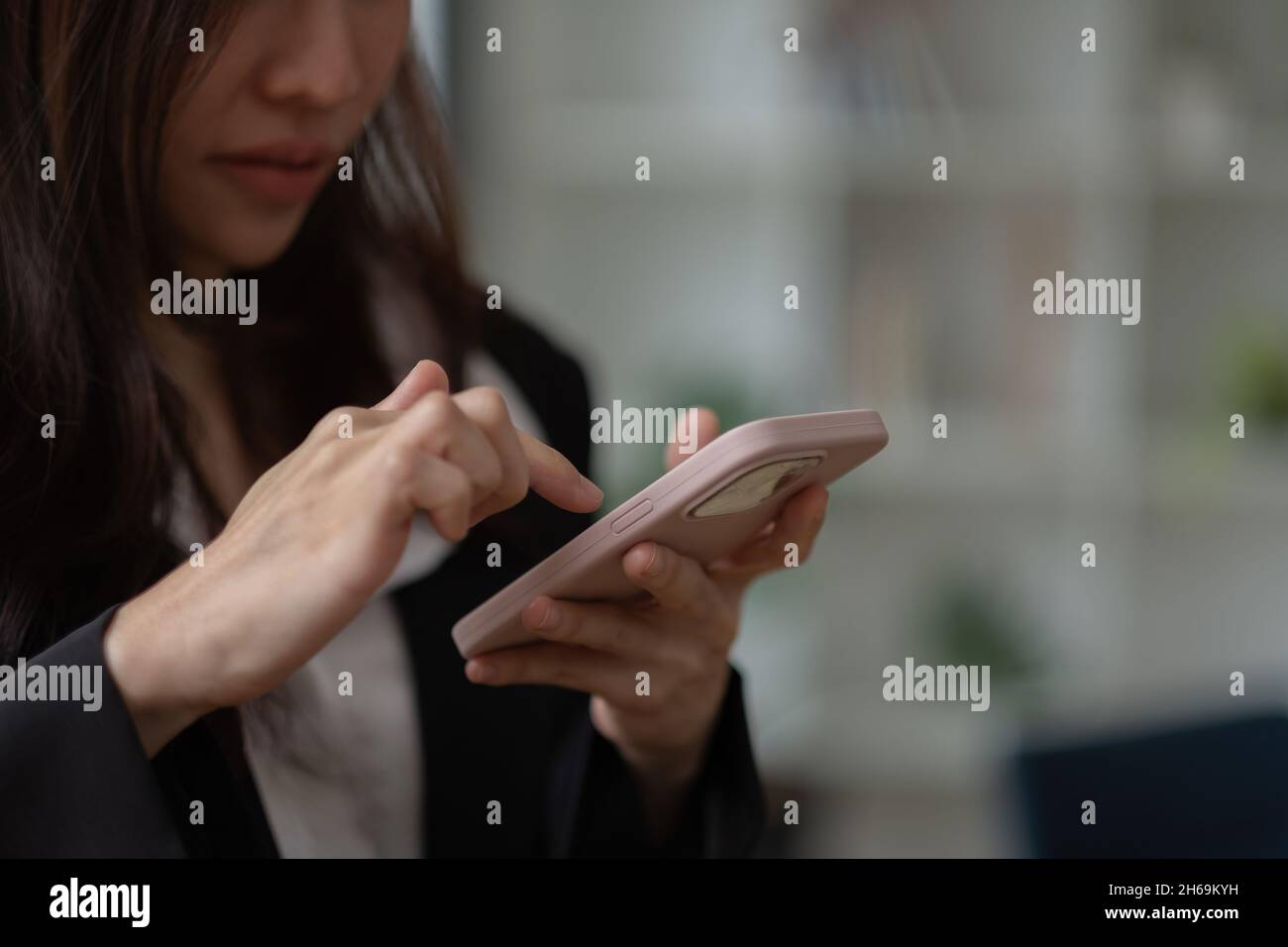 Asian girl using in hands mobile phone close up, online wi-fi internet Stock Photo