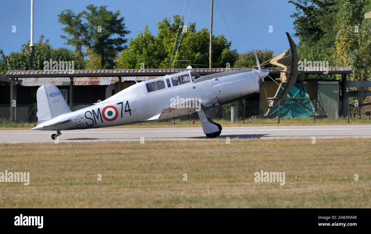 Rivolto del Friuli, Udine, Italy SEPTEMBER, 17, 2021 Tailwheel undercarriage grey two seats in tandem airplane side view on the runway. Fiat G.46 ex Italian Air Force Stock Photo