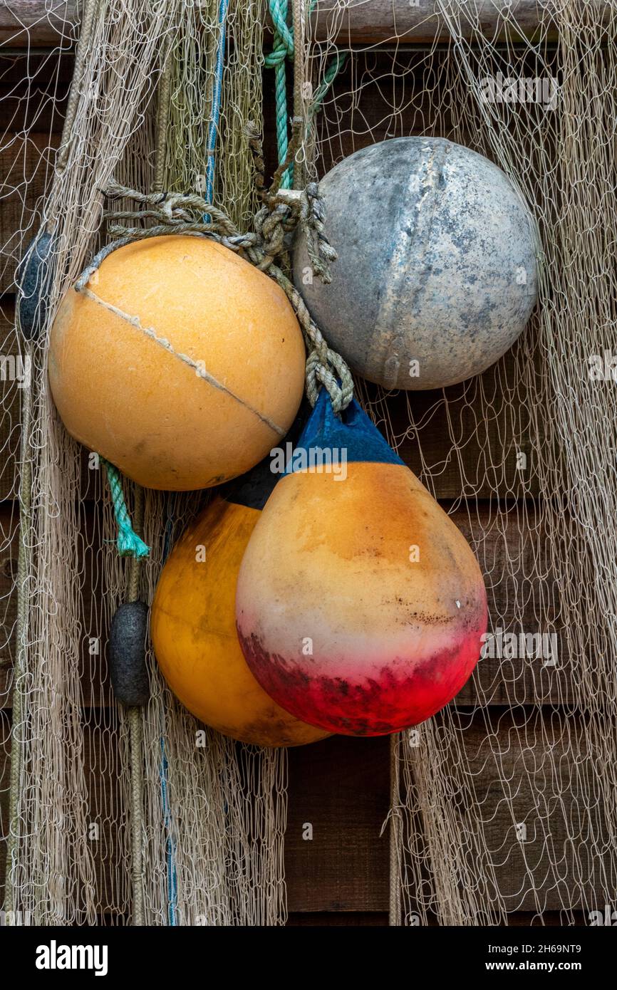 colourful fishing floats and fishing nets hanging to dry on the side of an  old wooden beach huts at steephill cove near ventnor on the isle of wight  Stock Photo - Alamy
