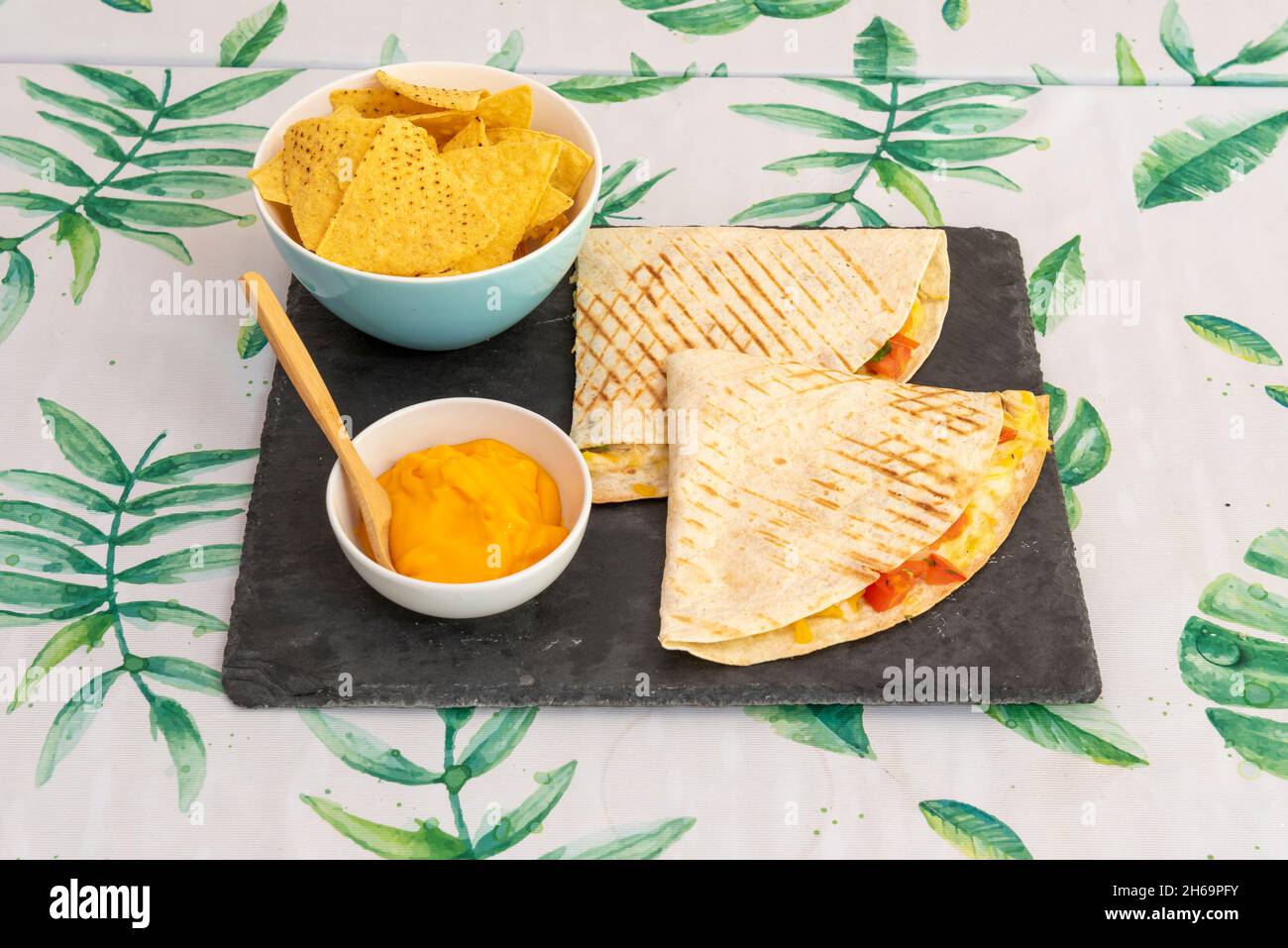 a corn or wheat tortilla, folded in half that can be filled with cheese, beans and chicken and eaten hot, either fried or cooked on the comal with cor Stock Photo