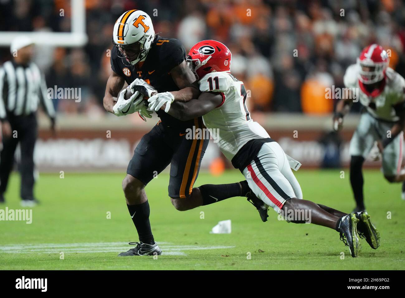 November 13, 2021: Cedric Tillman #4 of the Tennessee Volunteers runs with  the ball after a catch and is tackled by Derion Kendrick #11 of the Georgia  Bulldogs during the NCAA football