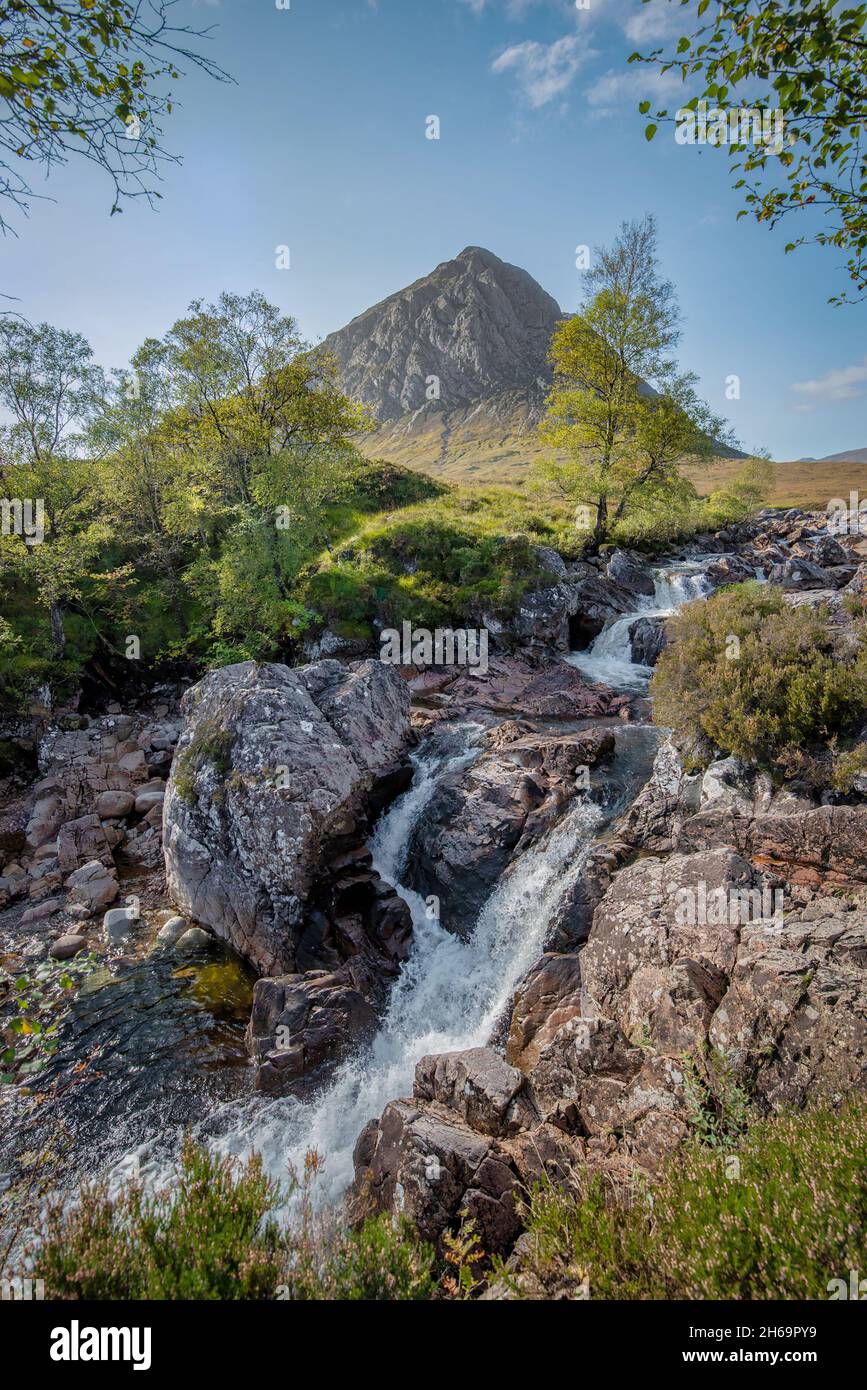Buachaille Etive Mòr, is a mountain at the head of Glen Etive in the Highlands of Scotland. picture shows the stream with the mountain in the back Stock Photo