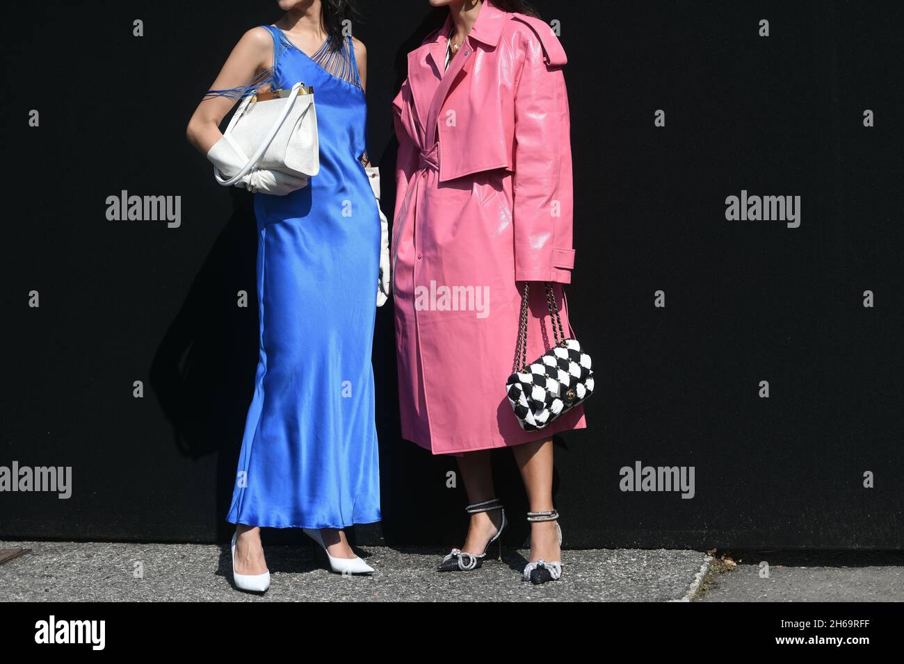 Milan, Italy - September 24, 2021: Street style outfit, two fashionable  women wearingpink oversized coat, checkered black white Chanel bag, heels  and Stock Photo - Alamy