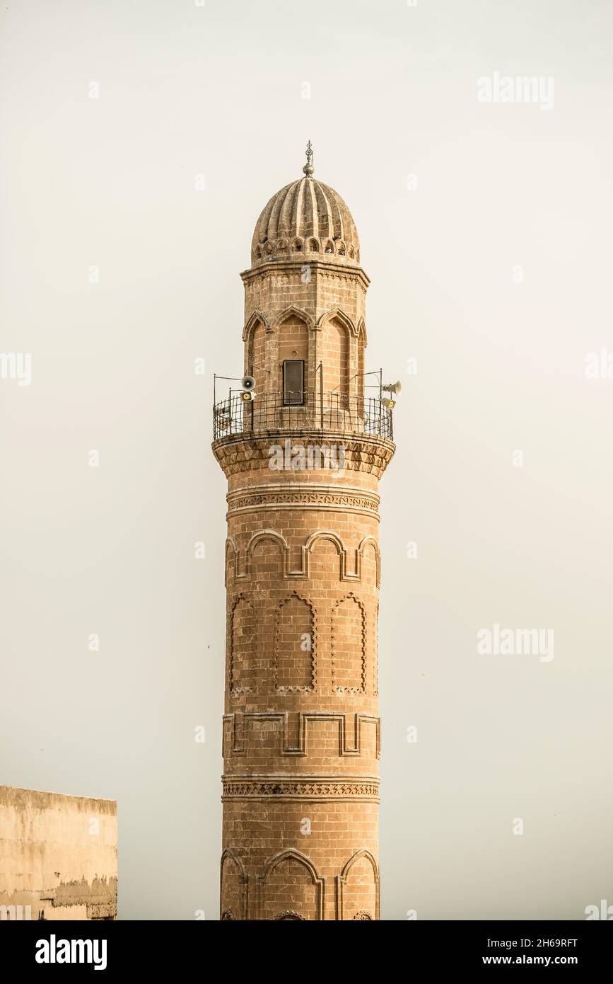 Minaret of ancient Ottoman architecture built with red sandstone with low relief ornamentation Stock Photo