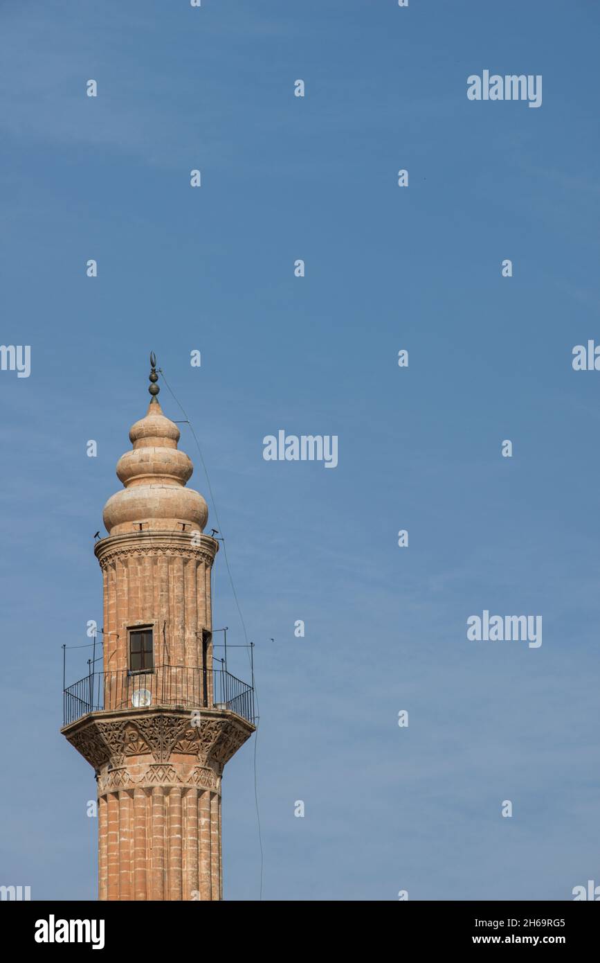Top of a minaret of ancient Ottoman architecture built with red sandstone with rounded domes and speakers for the call to prayer. Stock Photo