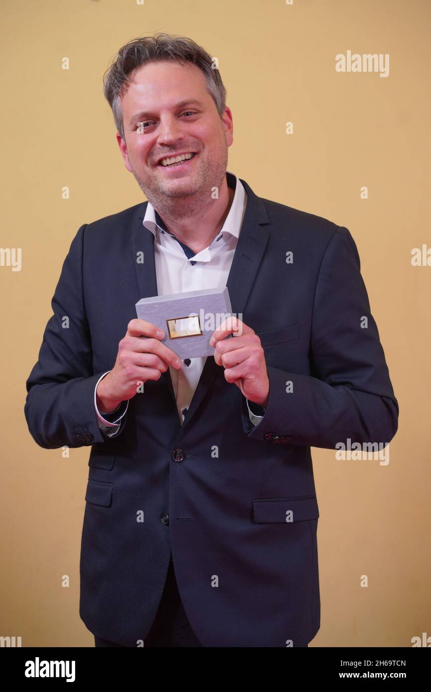 13 November 2021, Berlin: Matthias Bolliger receives an award in the category 'Picture Design' at the DAfF (German Academy for Television) awards ceremony at the Babylon cinema. Photo: Jörg Carstensen/dpa Stock Photo