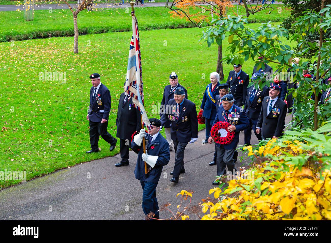 Bournemouth, Dorset UK. 14th November 2021. Remembrance Sunday Parade and wreath laying service - representatives of armed services, forces groups and cadets parade through Bournemouth gardens followed by a service and wreath laying at the War Memorial in Central Gardens. Crowds gather to pay their respects and remember the fallen on a mild day. This year coincides with the centenary year of the Royal British Legion. Veterans march through the garden. Credit: Carolyn Jenkins/Alamy Live News Stock Photo