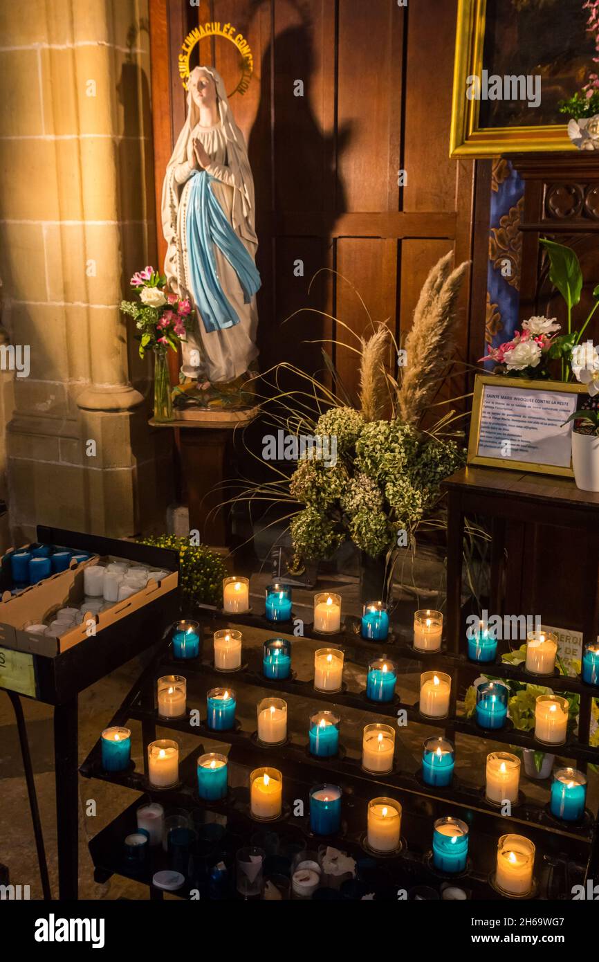 Burning candles and Maria statue in the historic cathedral of Bayonne, France Stock Photo