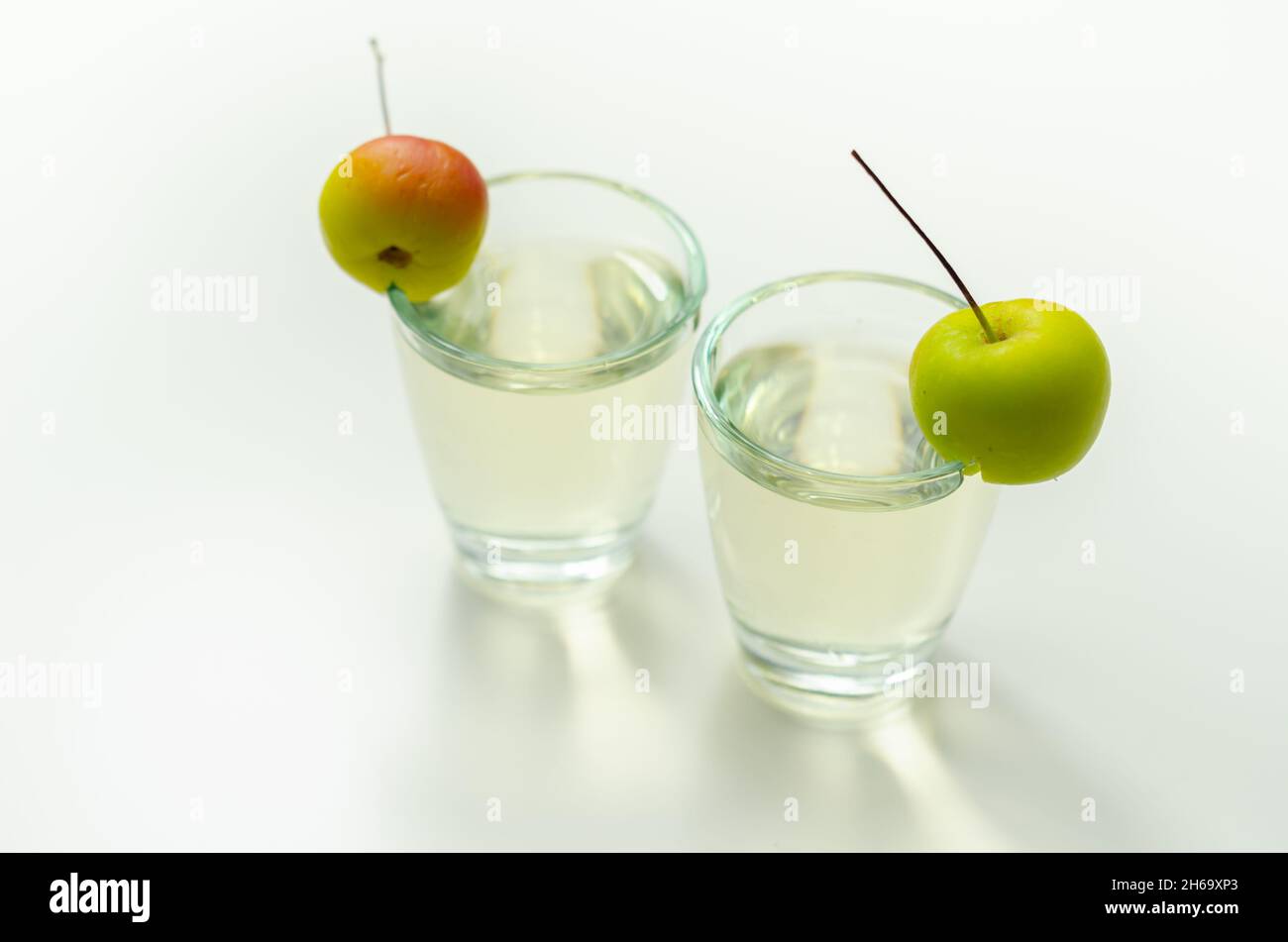 Delicious Calvados served in shot glasses decorated with crab apples, an alcoholic drink made of