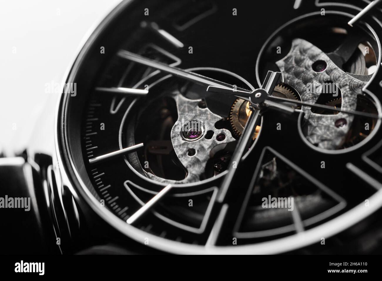 Swiss mechanical skeleton wrist watch with black metal deal and shiny high-tech ceramic body. Close-up photo. It is a watch type in which all of the m Stock Photo