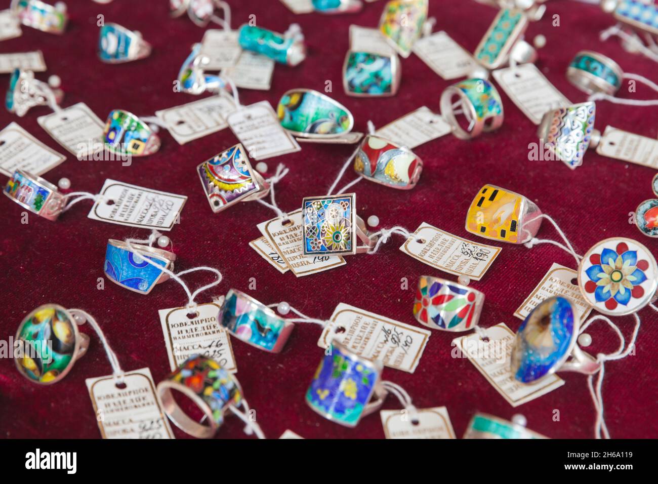 Tbilisi, Georgia - April 28, 2019: Handmade jewelry for sale made by Minankari or cloisonne enamel lay on a counter of a local gift shop. This jewelry Stock Photo