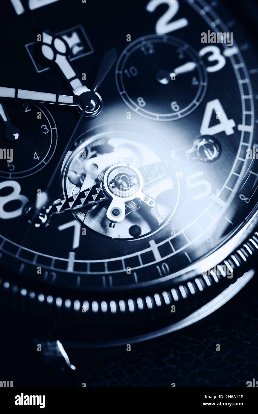 Automatic mechanic wrist watch, close-up vertical blue toned photo Stock Photo