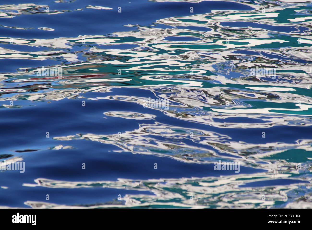 Patterns and colours in reflections of boats in harbour water Stock ...