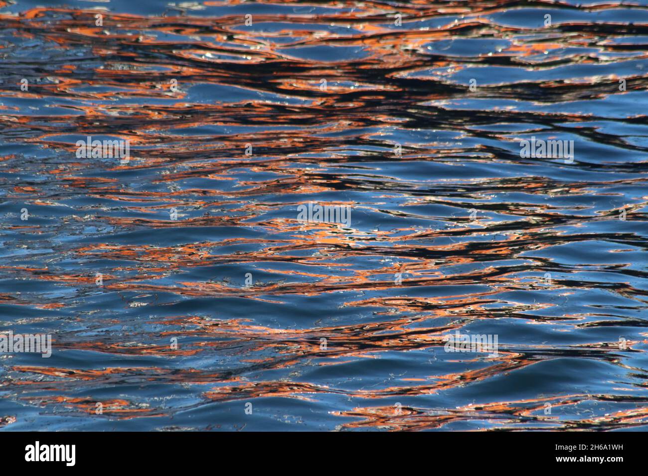 Patterns and colours in reflections of boats in harbour water Stock ...