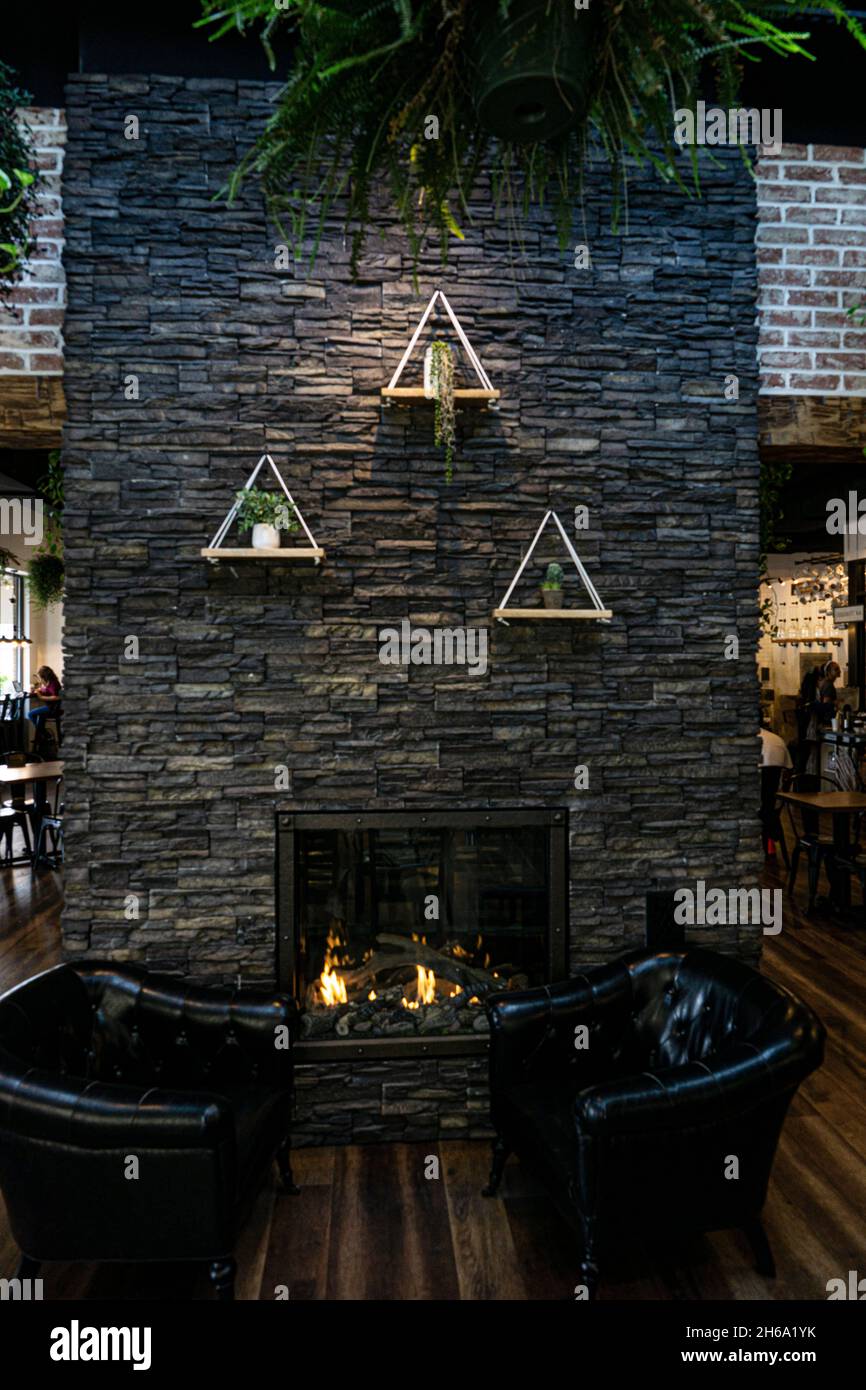 Interior of a cafe or a restaurant with stone brick wall and hanging ...