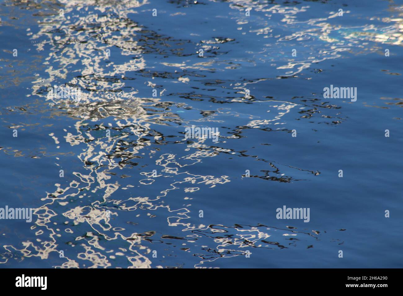 Patterns and colours in reflections of boats in harbour water Stock ...