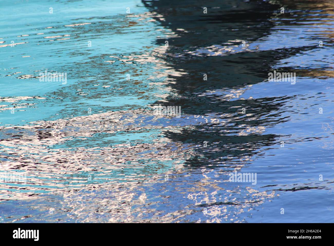 Patterns and colours in reflections of boats in harbour water Stock ...