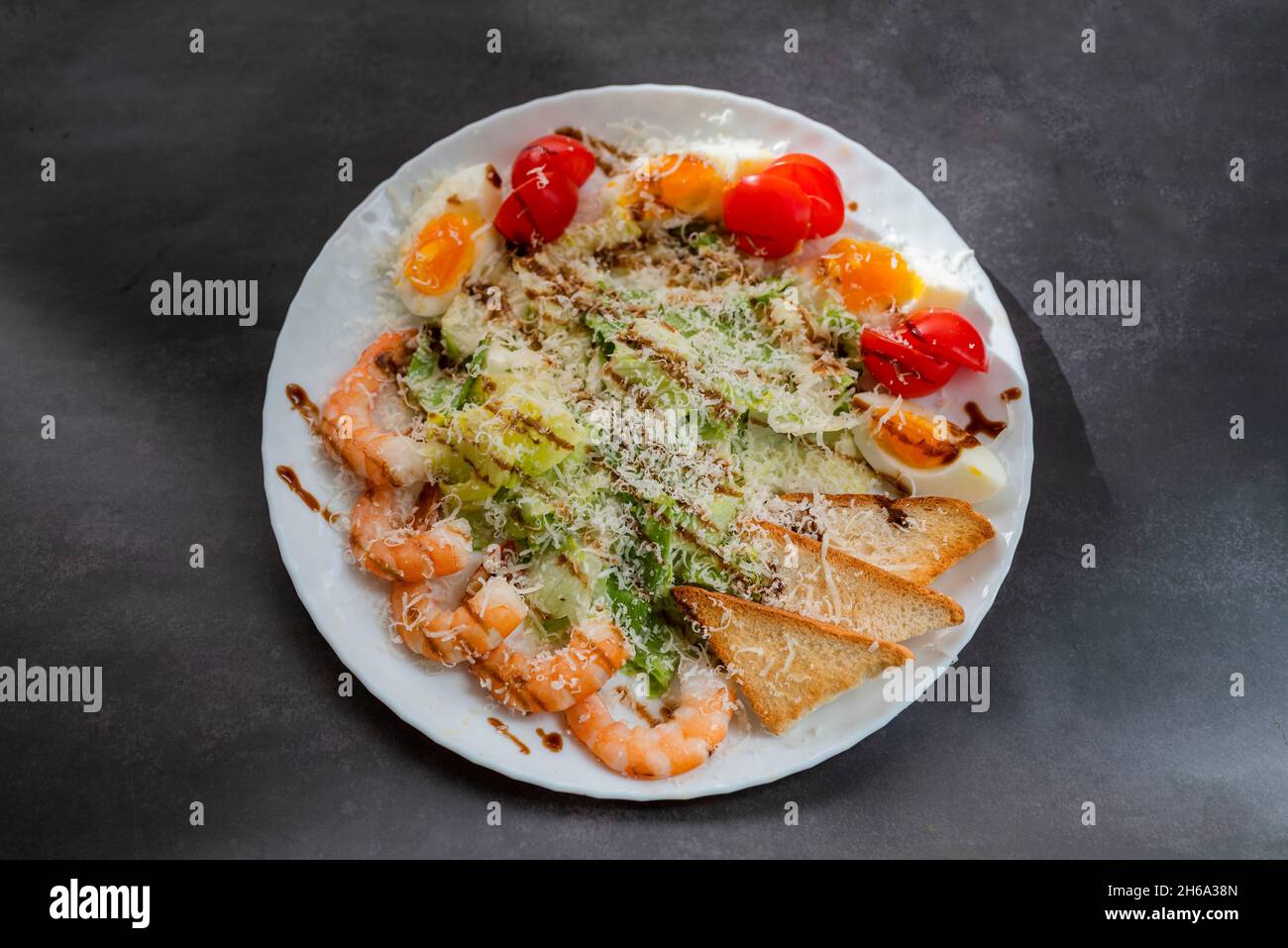 Caesar salad dish with shrimp lettuce and cherry tomatoes Stock Photo