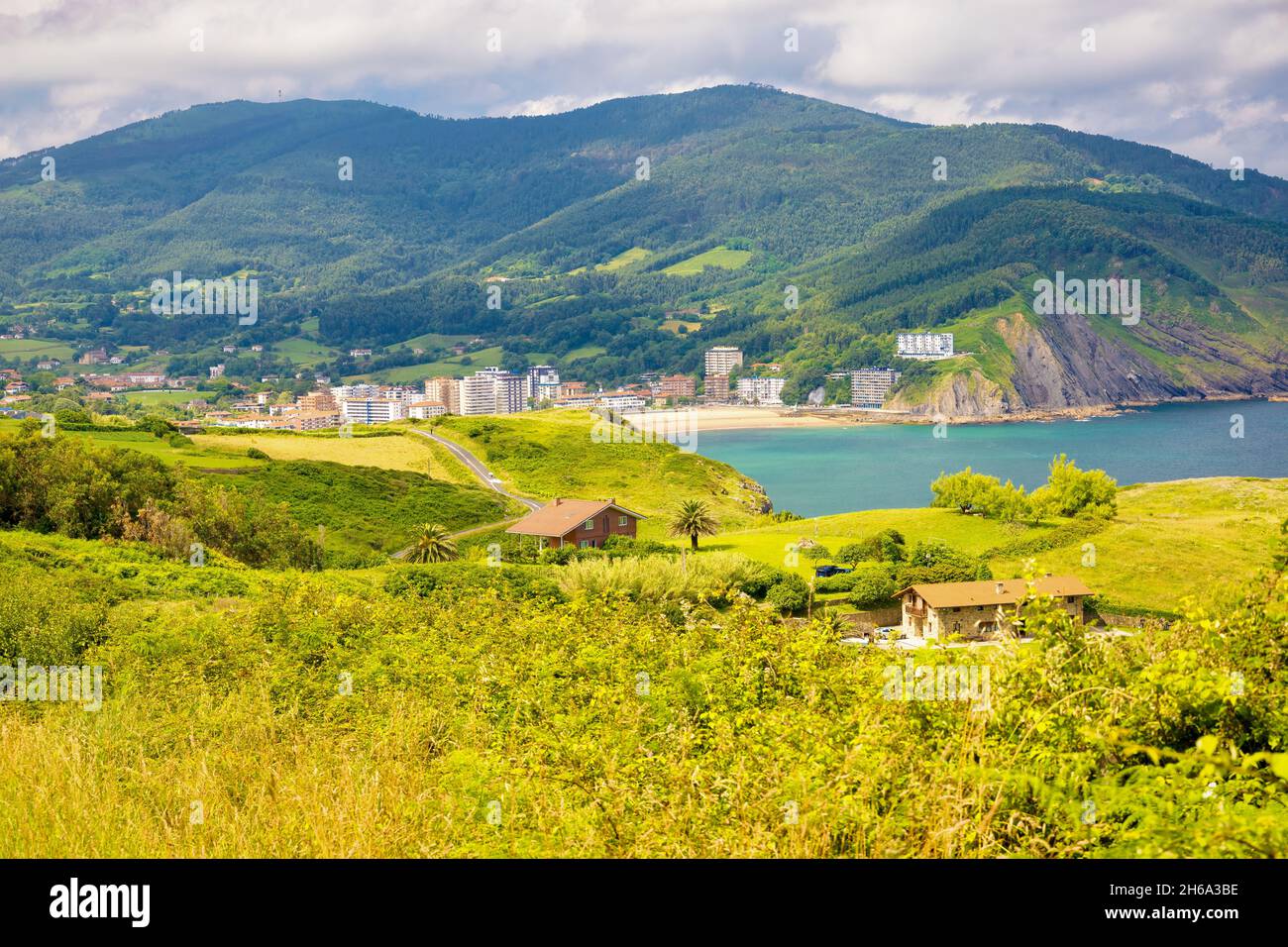 The road that runs along the coast leads to Bakio beach that can be seen in the background. Euskadi, Spain Stock Photo