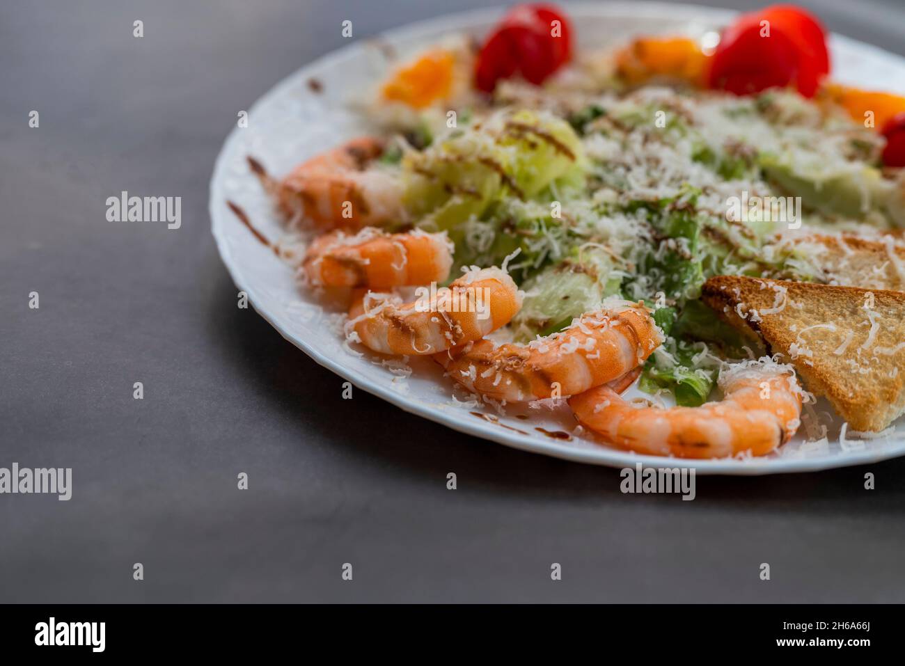 Caesar salad dish with shrimp lettuce and cherry tomatoes Stock Photo
