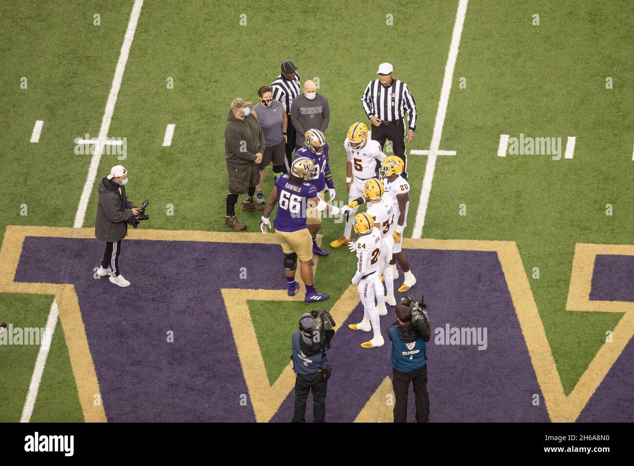 Washington Huskies and Arizona State Sun Devils captains meet on the field for the coin toss to start off an NCAA college football game, Saturday, Nov Stock Photo