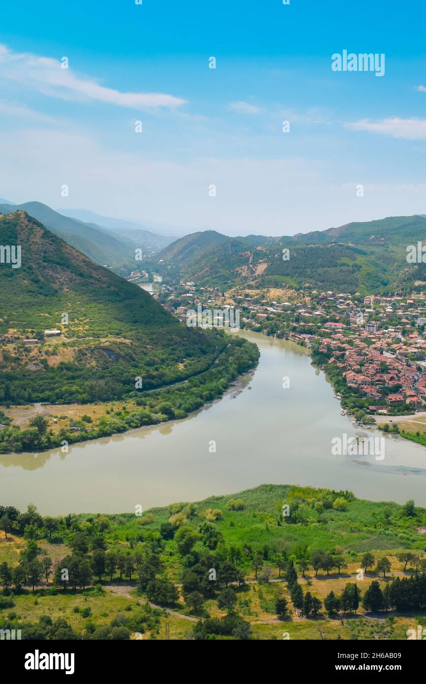 The top view of Mtskheta, Georgia. The historical town lies at the confluence of the rivers Mtkvari and Aragvi. Georgian landscape with blue sky above Stock Photo