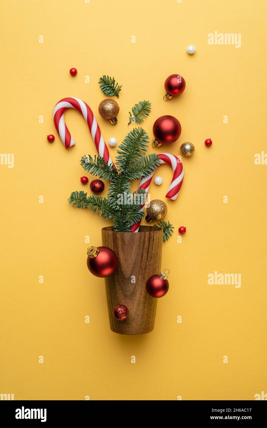 Christmas card with Christmas tree ornaments on yellow background Stock Photo