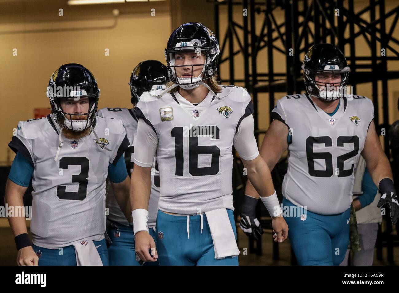 Indianapolis, Indiana, USA. 14th Nov, 2021. Jacksonville Jaguars quarterback C.J. Beathard (3), Jacksonville Jaguars quarterback Trevor Lawrence (16) and Jacksonville Jaguars offensive tackle KC McDermott (62) walk on to the field prior to the game between the Jacksonville Jaguars and the Indianapolis Colts at Lucas Oil Stadium, Indianapolis, Indiana. (Credit Image: © Scott Stuart/ZUMA Press Wire) Stock Photo