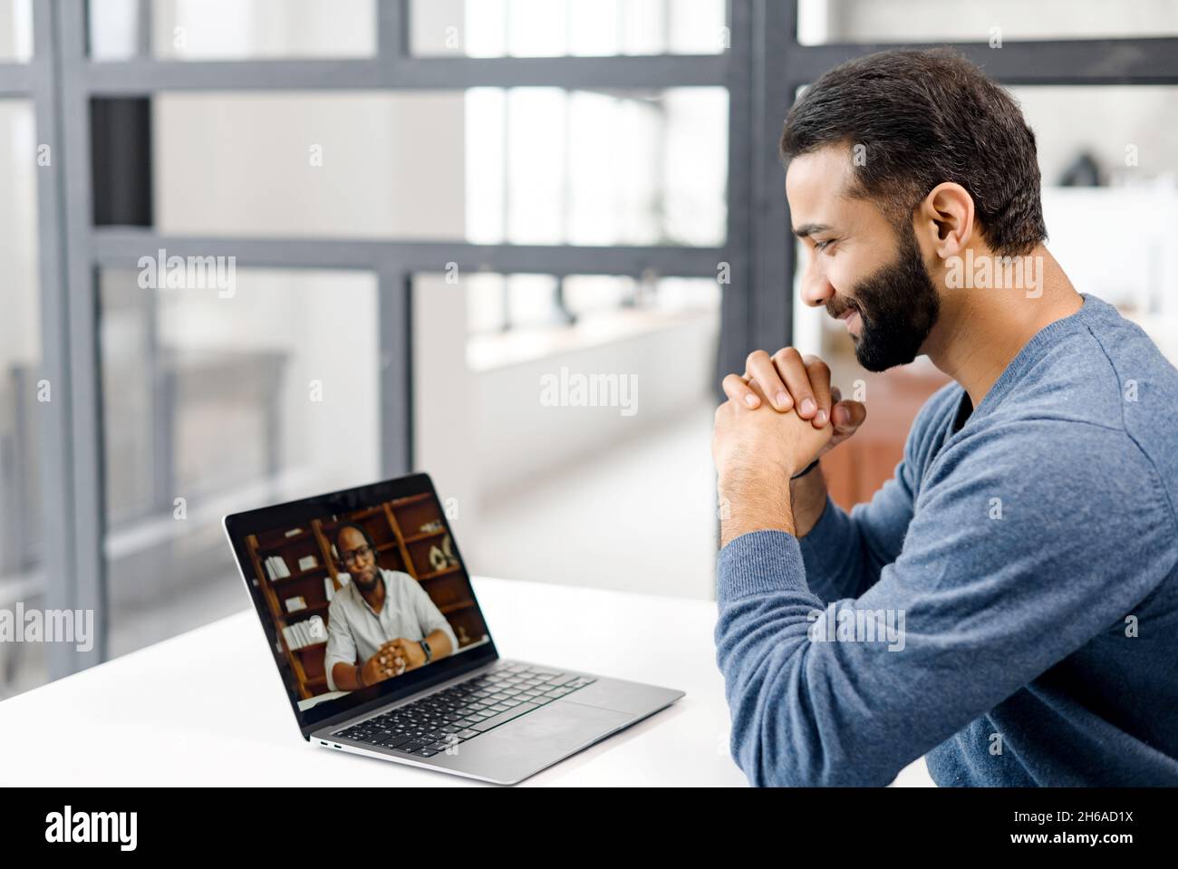 Two diverse male colleagues taking part in video meeting. Multiracial ...