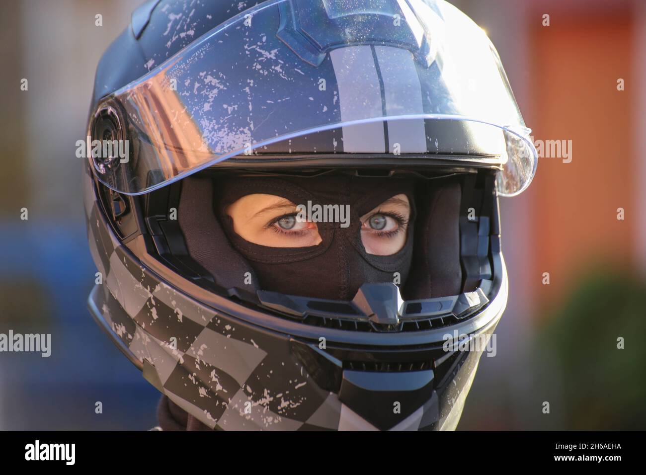 Female race car driver wears helmet and balaclava (model released Stock