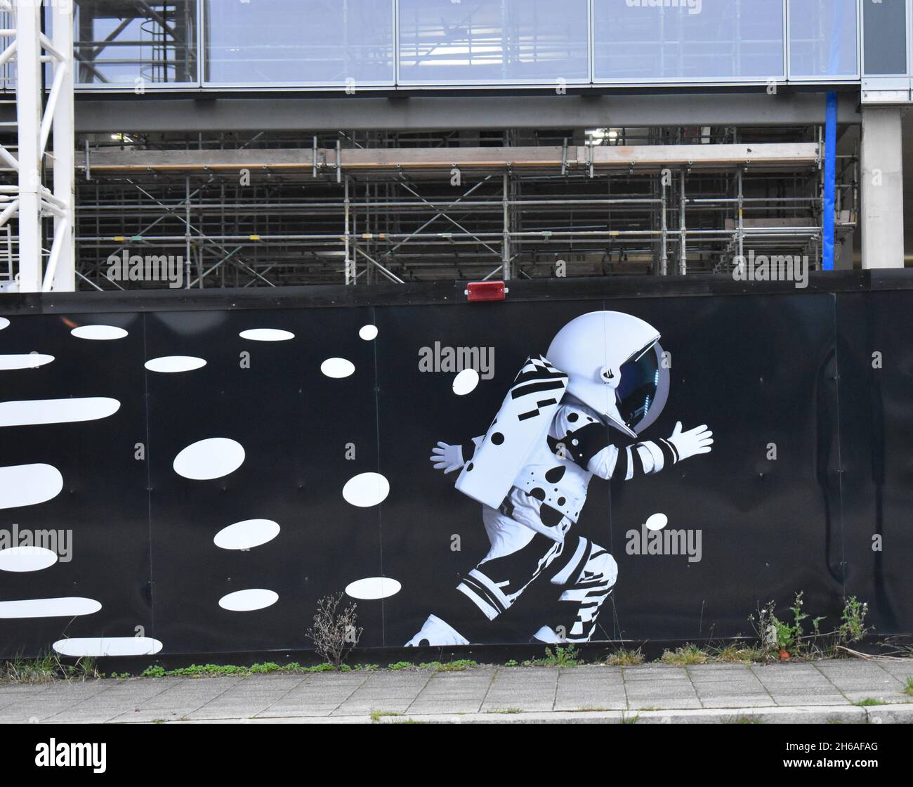 Astronaut mural on a hoarding at a building site in Central Milton Keynes. Stock Photo