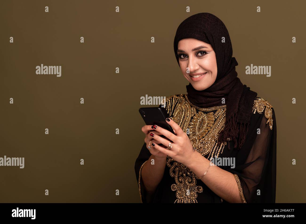 Portrait of beautiful young muslim arabian woman wearing hijab looking ...